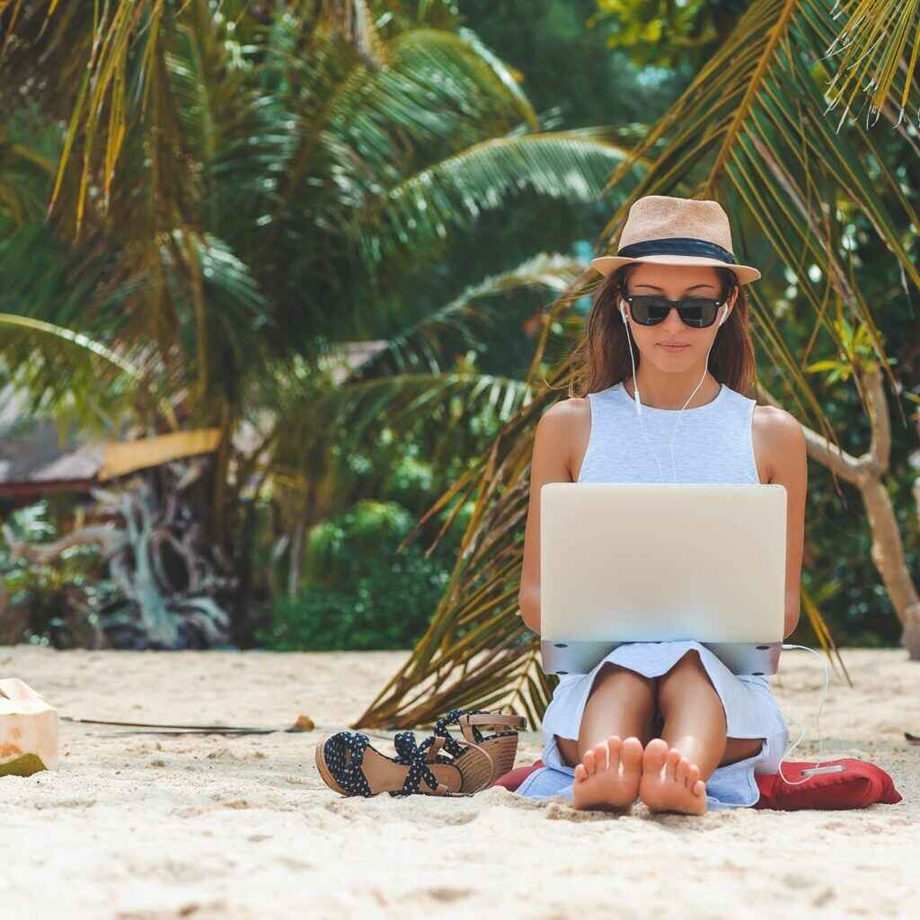 digital nomad working on the beach